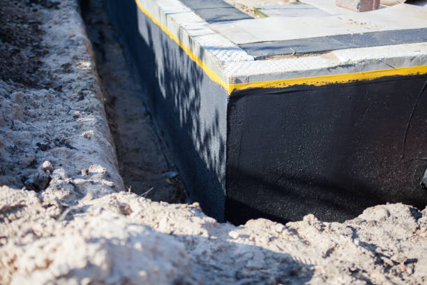 Professional Waterproofing technician working in Roosevelt, NY